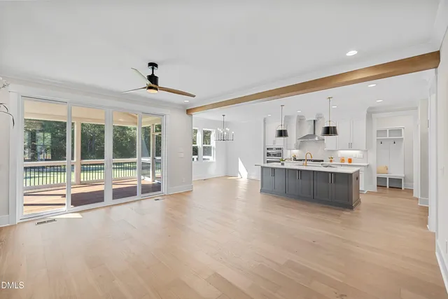 a large white kitchen with a large window