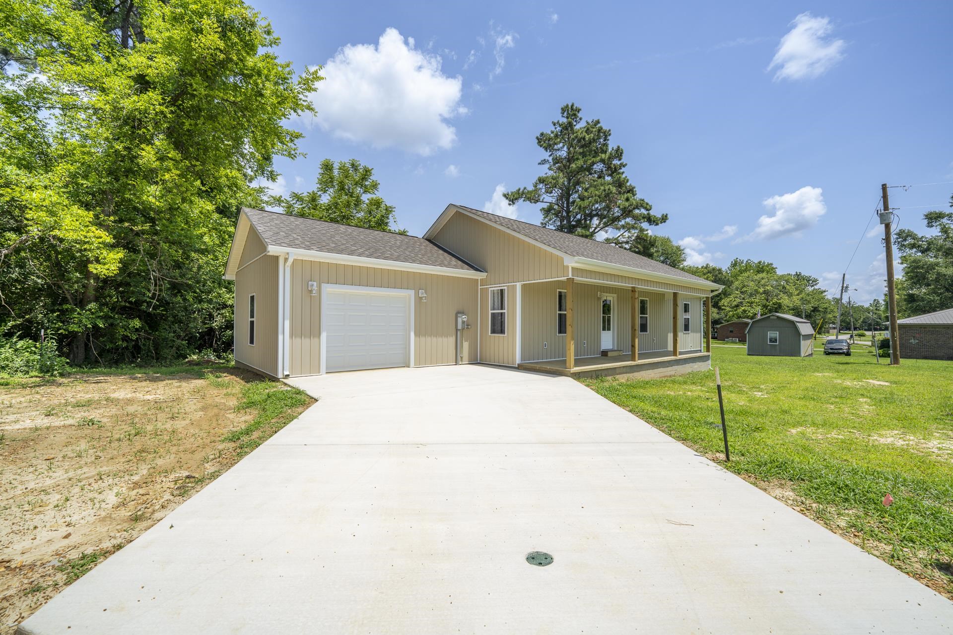 231 Clausel Lane Adamsville, TN 38310 - Photo 28 of 32 a front view of a house with a yard and garage