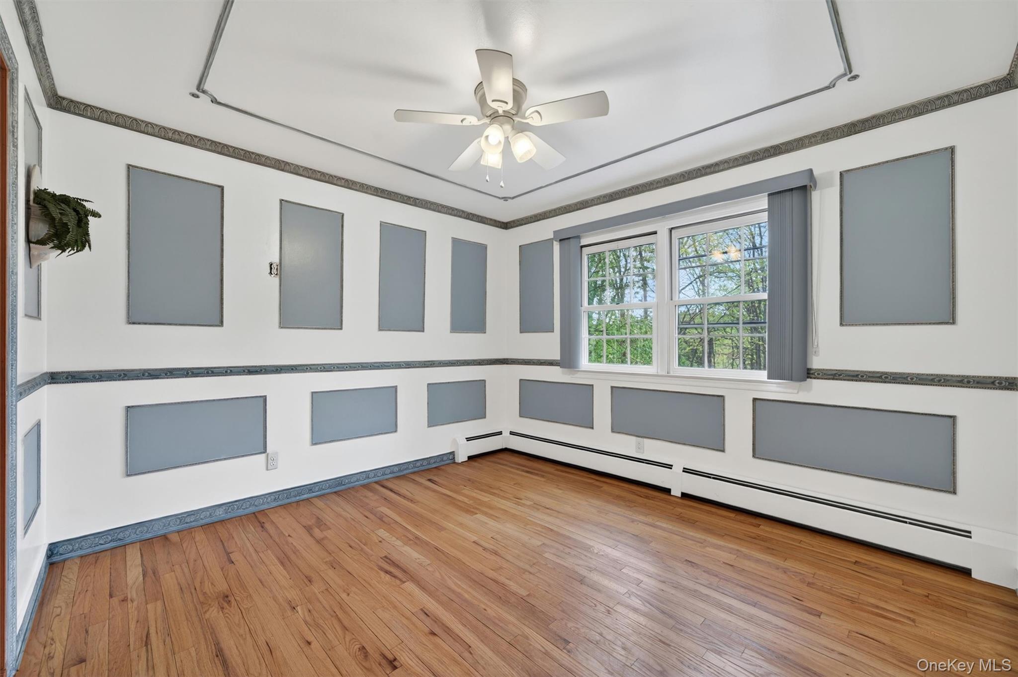 155 Pine Tree Road Monroe, NY 10950 - Photo 9 of 49 a view of an empty room with a window and wooden floor