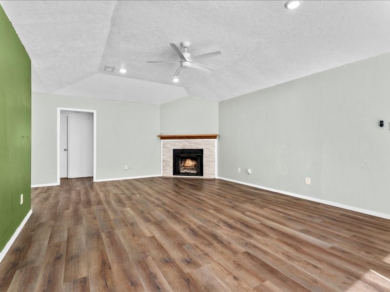 6631 Ambler Drive Spring, TX 77379 - Photo 13 of 37 wooden floor in an empty room with a fireplace