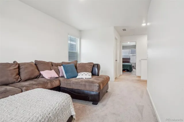 a living room with furniture and a lamp