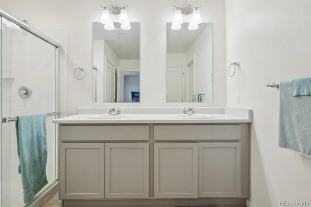 a bathroom with a sink vanity and a mirror