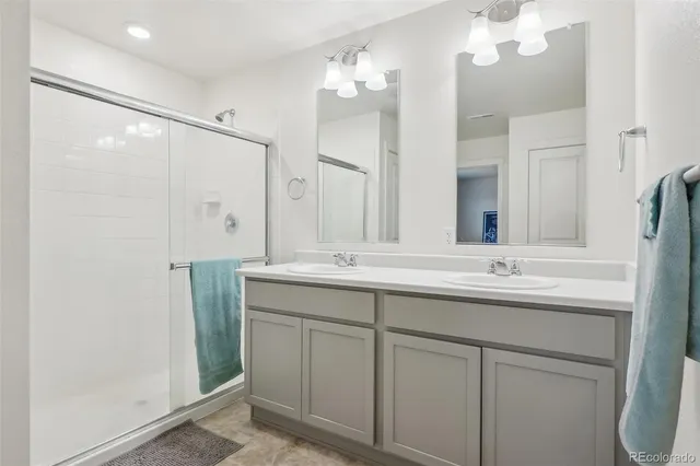 a bathroom with a double vanity sink and mirror