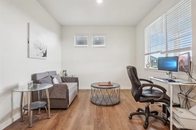 a view of a workspace with furniture and a window