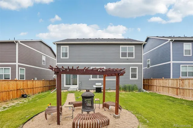 a view of house with backyard
