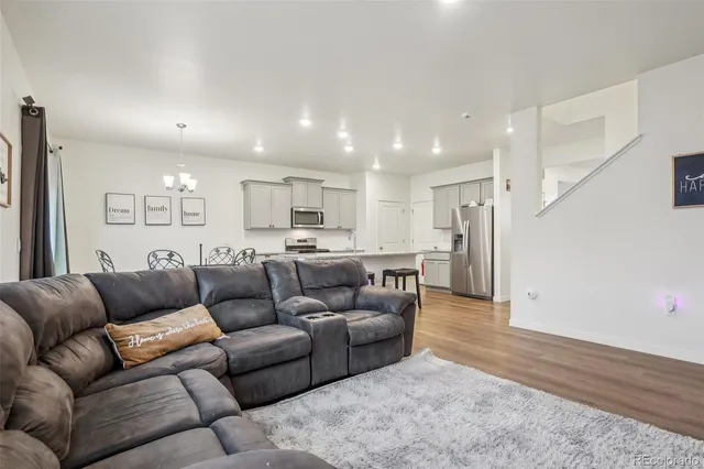 a living room with furniture and kitchen view