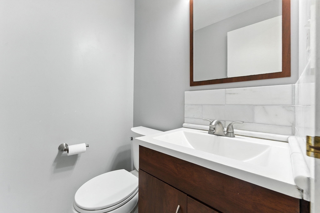 22 Chestnut Place, Unit 608 Brookline, MA 02445 - Photo 16 of 29 a bathroom with a sink a toilet and mirror