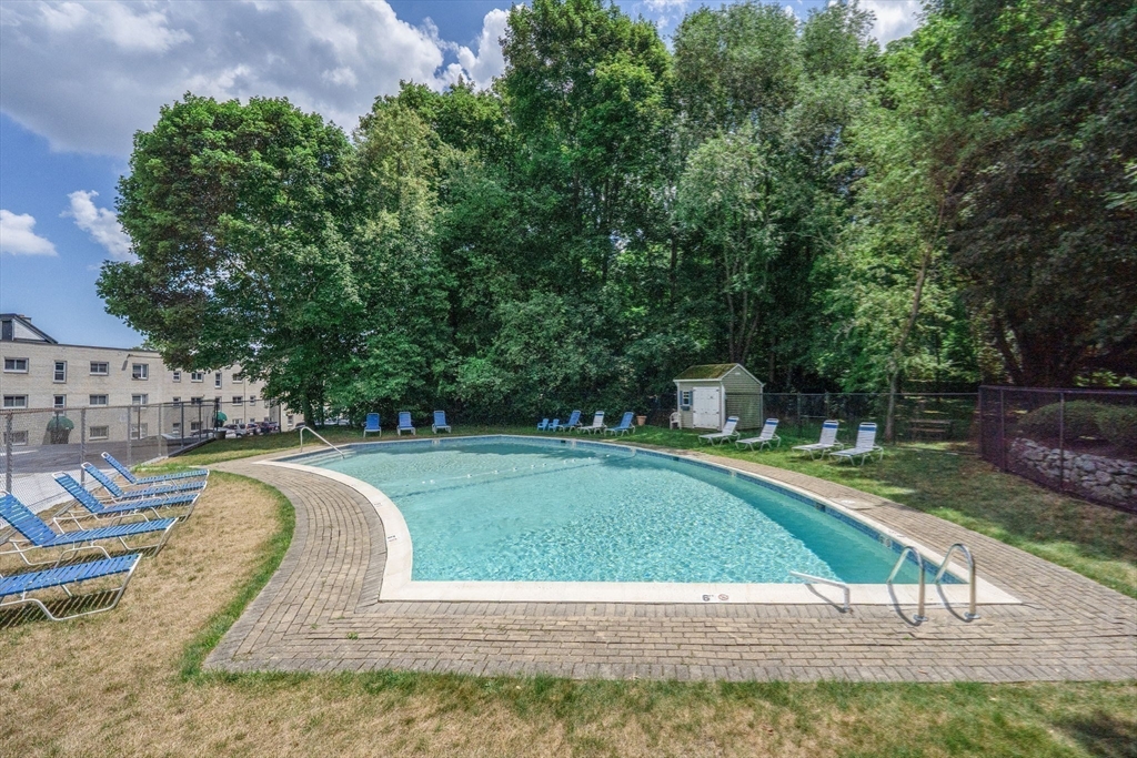 22 Chestnut Place, Unit 608 Brookline, MA 02445 - Photo 19 of 29 a view of a swimming pool with a patio