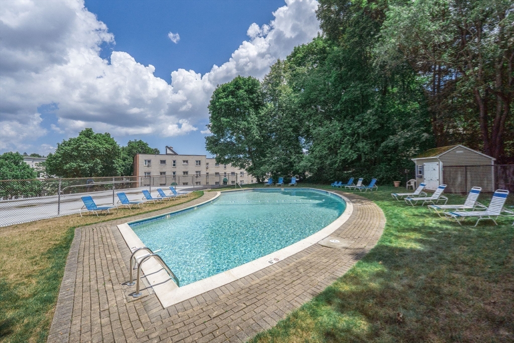 22 Chestnut Place, Unit 608 Brookline, MA 02445 - Photo 20 of 29 a view of a swimming pool with a garden