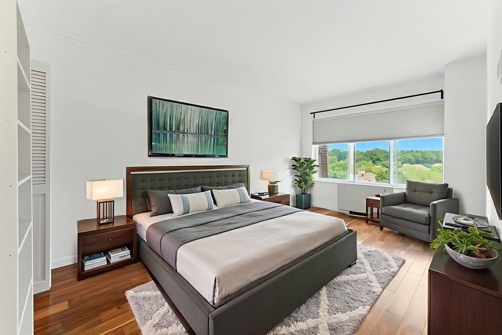 22 Chestnut Place, Unit 608 Brookline, MA 02445 - Photo 2 of 29 a bedroom with bed and a couch