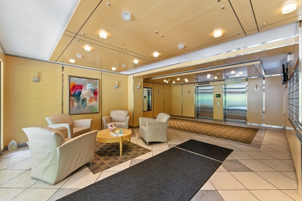 22 Chestnut Place, Unit 608 Brookline, MA 02445 - Photo 28 of 29 a lobby with furniture and window