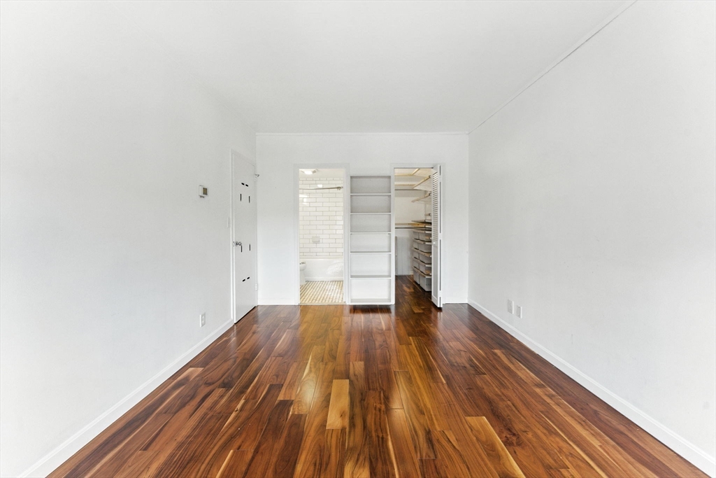 22 Chestnut Place, Unit 608 Brookline, MA 02445 - Photo 9 of 29 a view of empty room with wooden floor