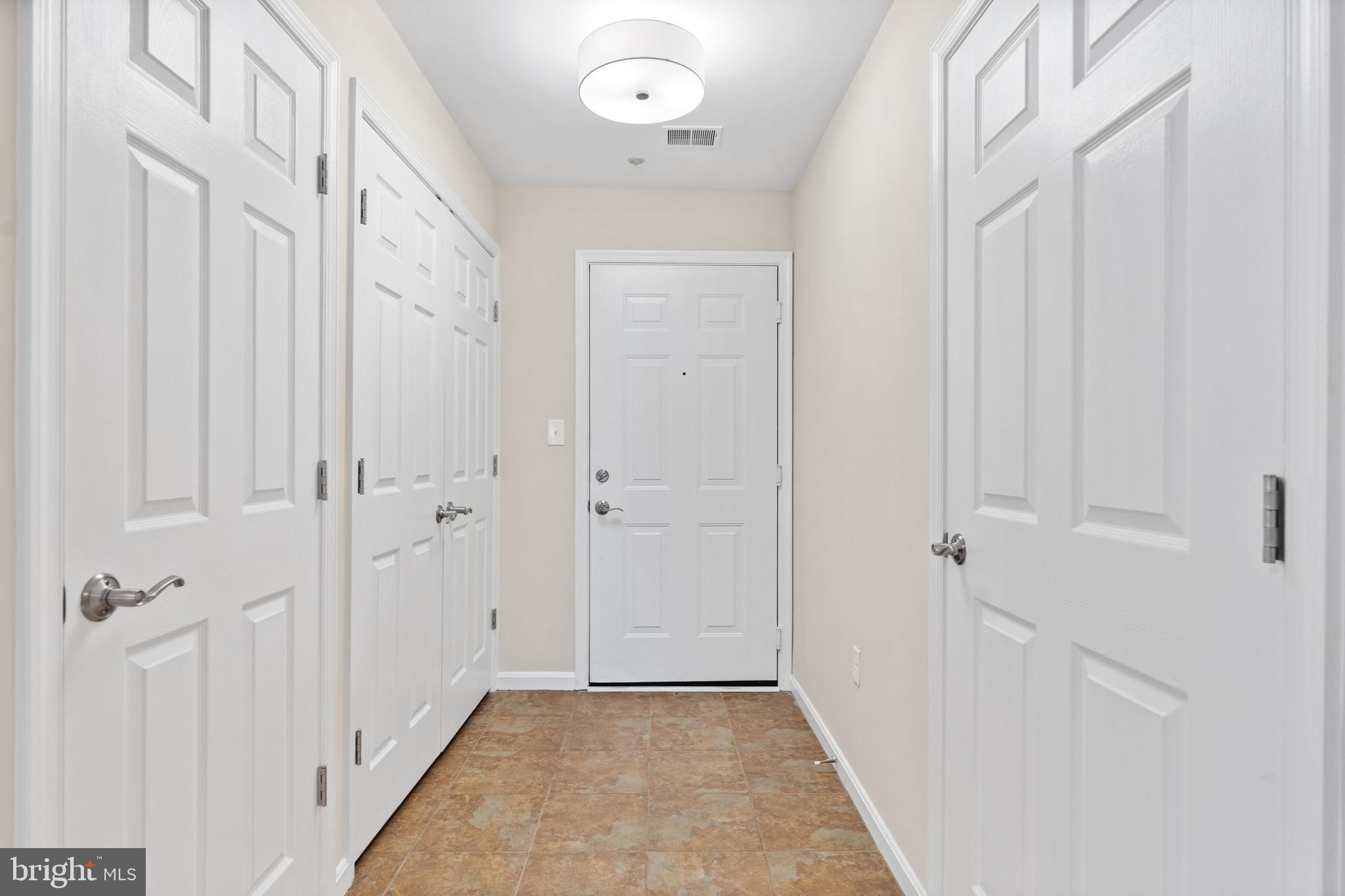 112 Kendrick Place, Unit 14 Gaithersburg, MD 20878 - Photo 3 of 37 Formal entry foyer with guests closet & laundry