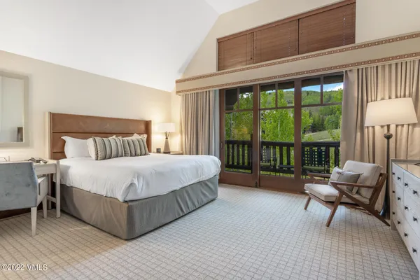 a bedroom with a bed and a large window