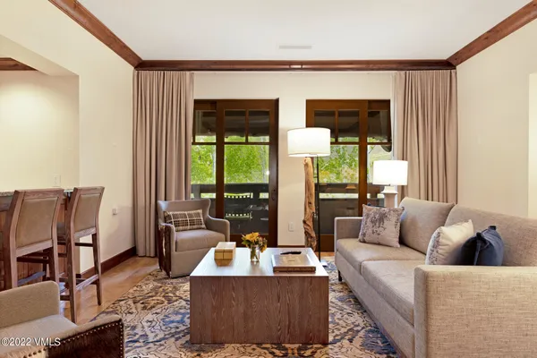 a living room with furniture and large windows