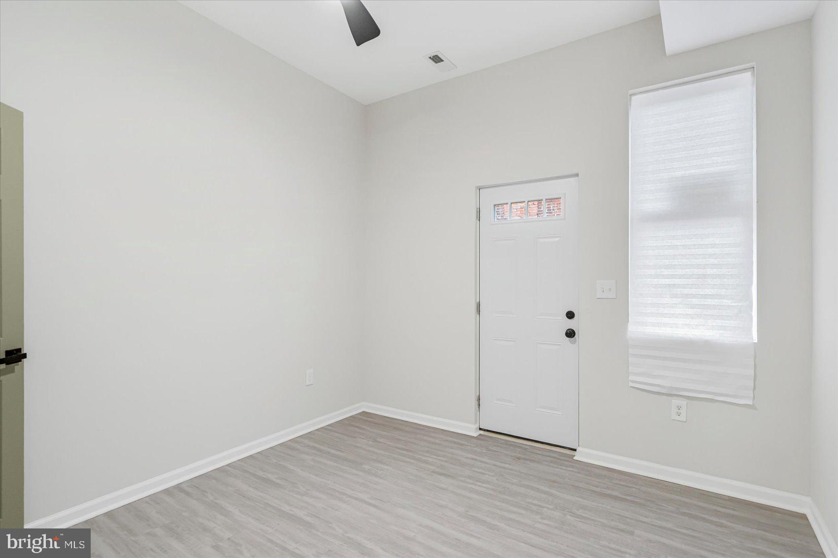 1743 Federal Street Baltimore, MD 21213 - Photo 13 of 47 an empty room with wooden floor and window