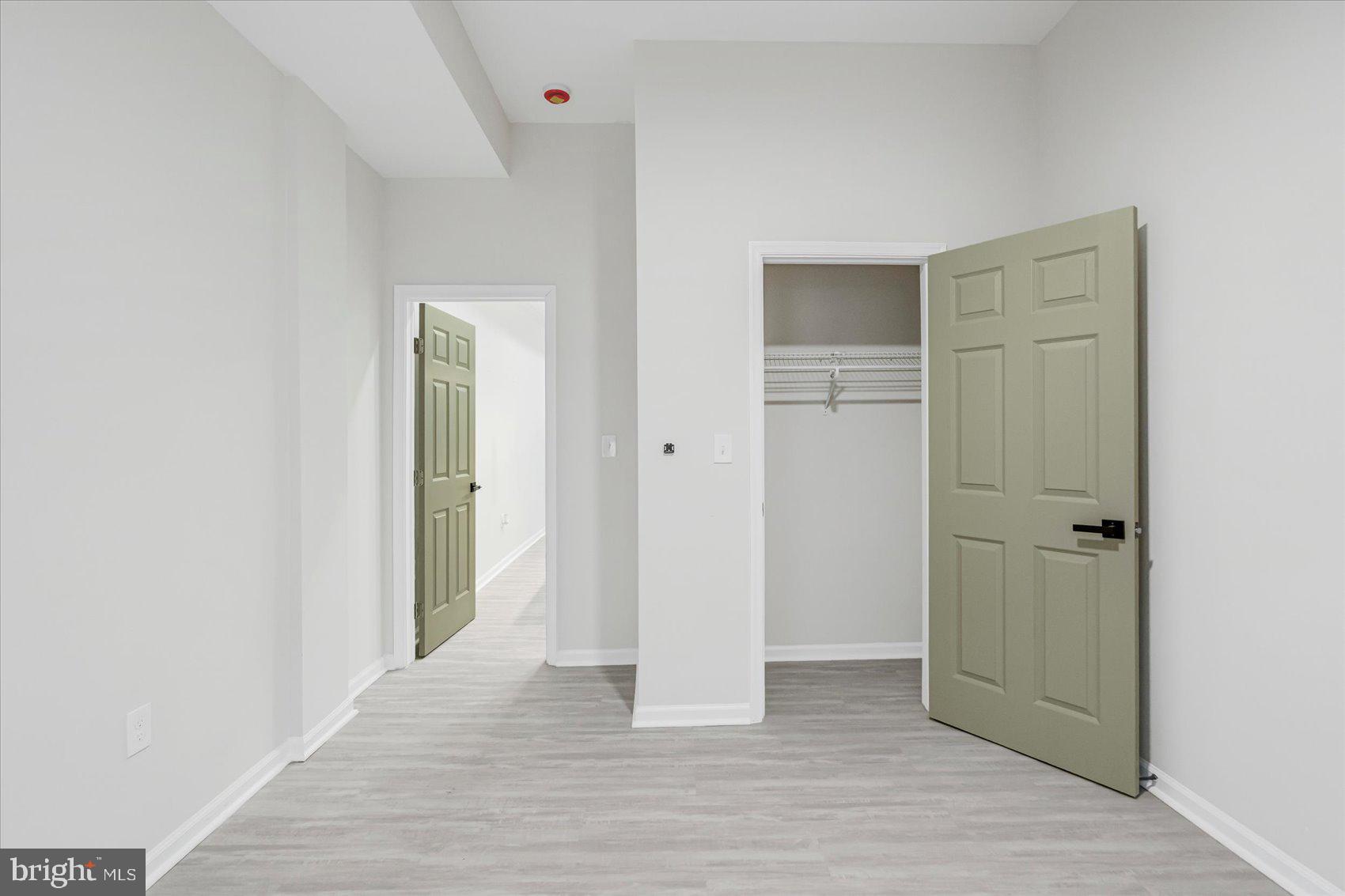1743 Federal Street Baltimore, MD 21213 - Photo 14 of 47 an empty room with wooden floor and closet