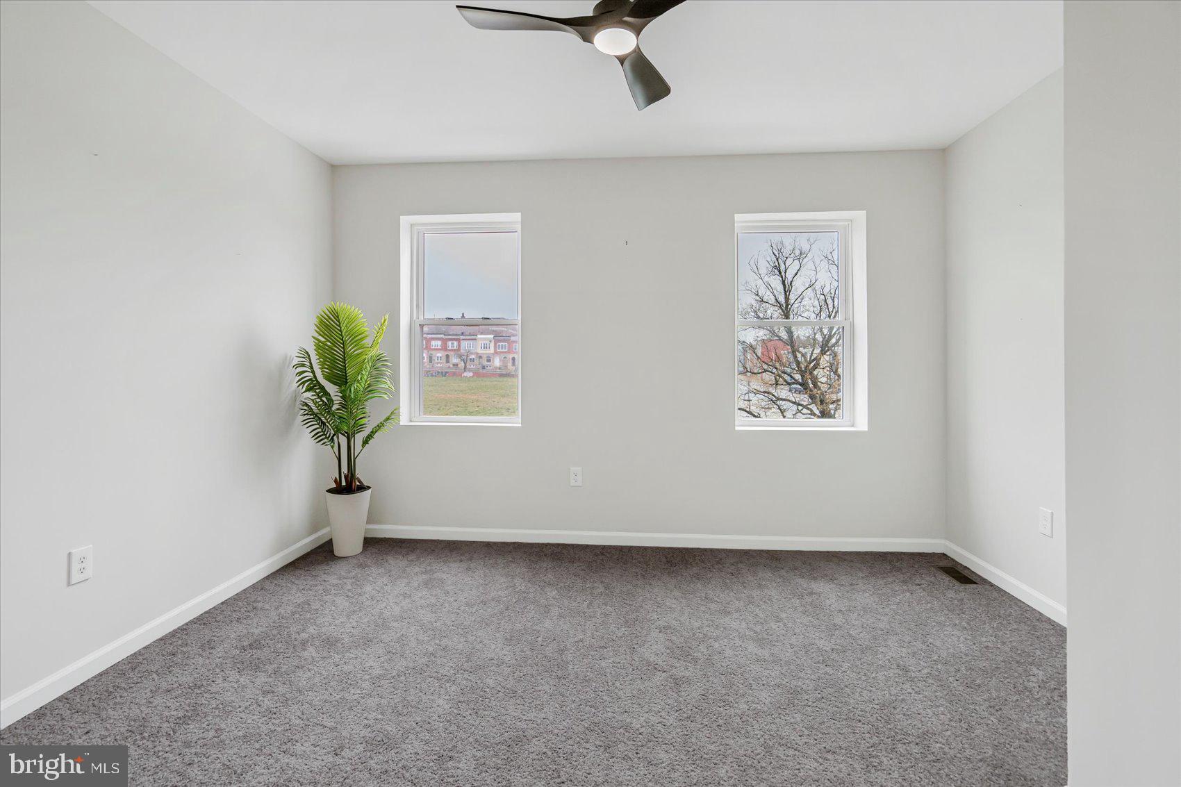 1743 Federal Street Baltimore, MD 21213 - Photo 18 of 47 an empty room with windows and wooden floor