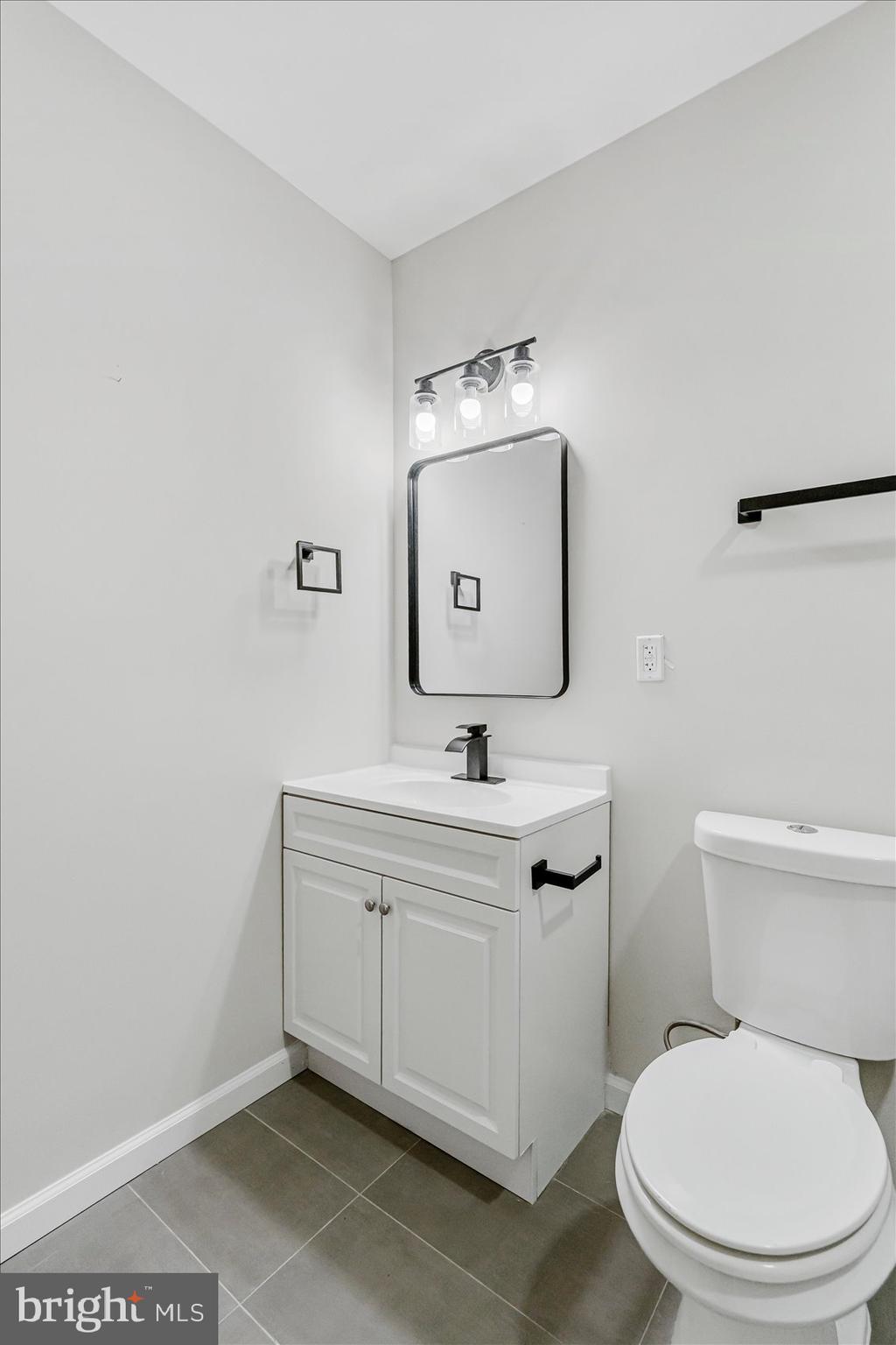 1743 Federal Street Baltimore, MD 21213 - Photo 23 of 47 a bathroom with a toilet a sink and mirror