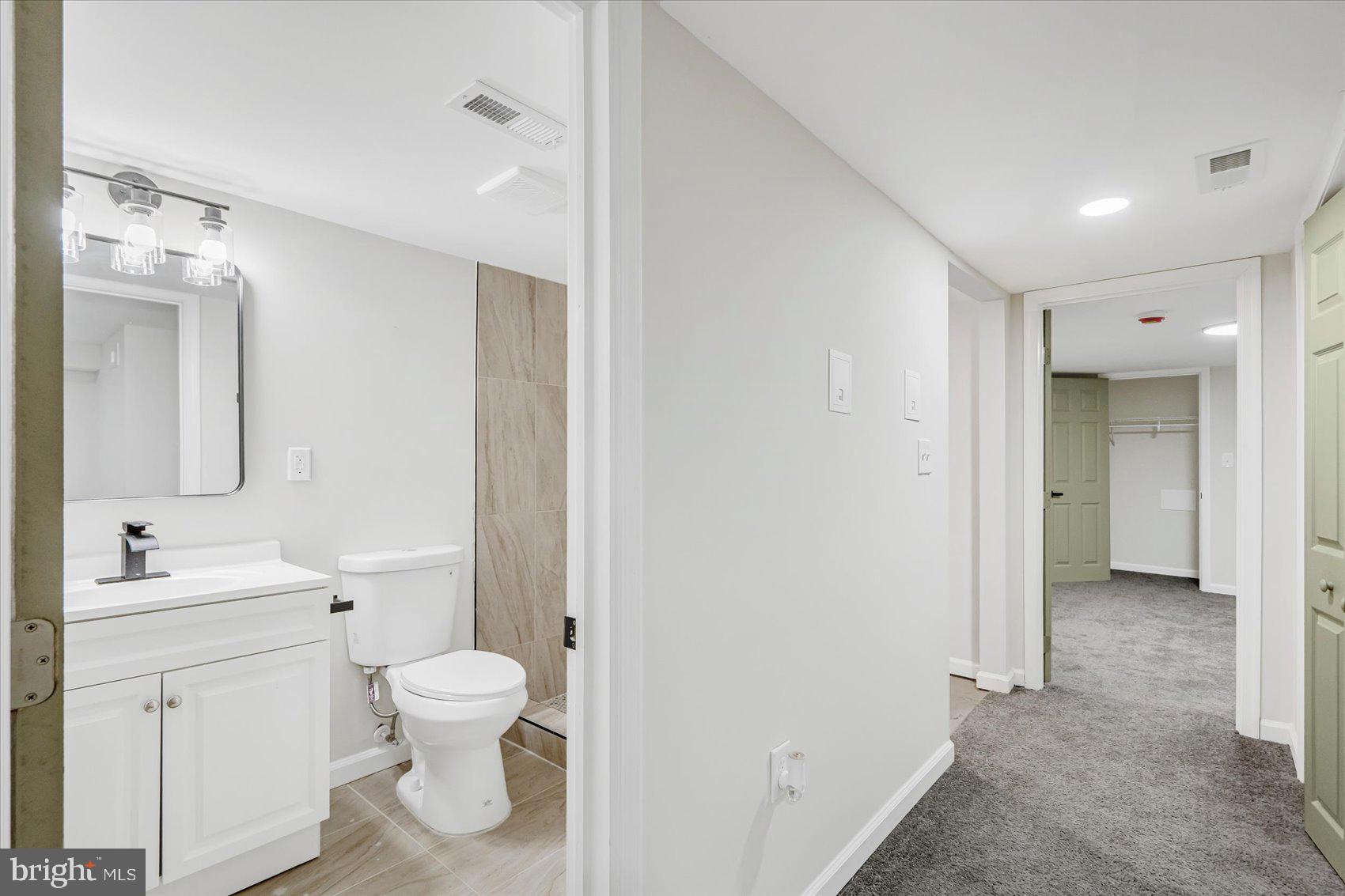 1743 Federal Street Baltimore, MD 21213 - Photo 34 of 47 a bathroom with a toilet sink and a mirror