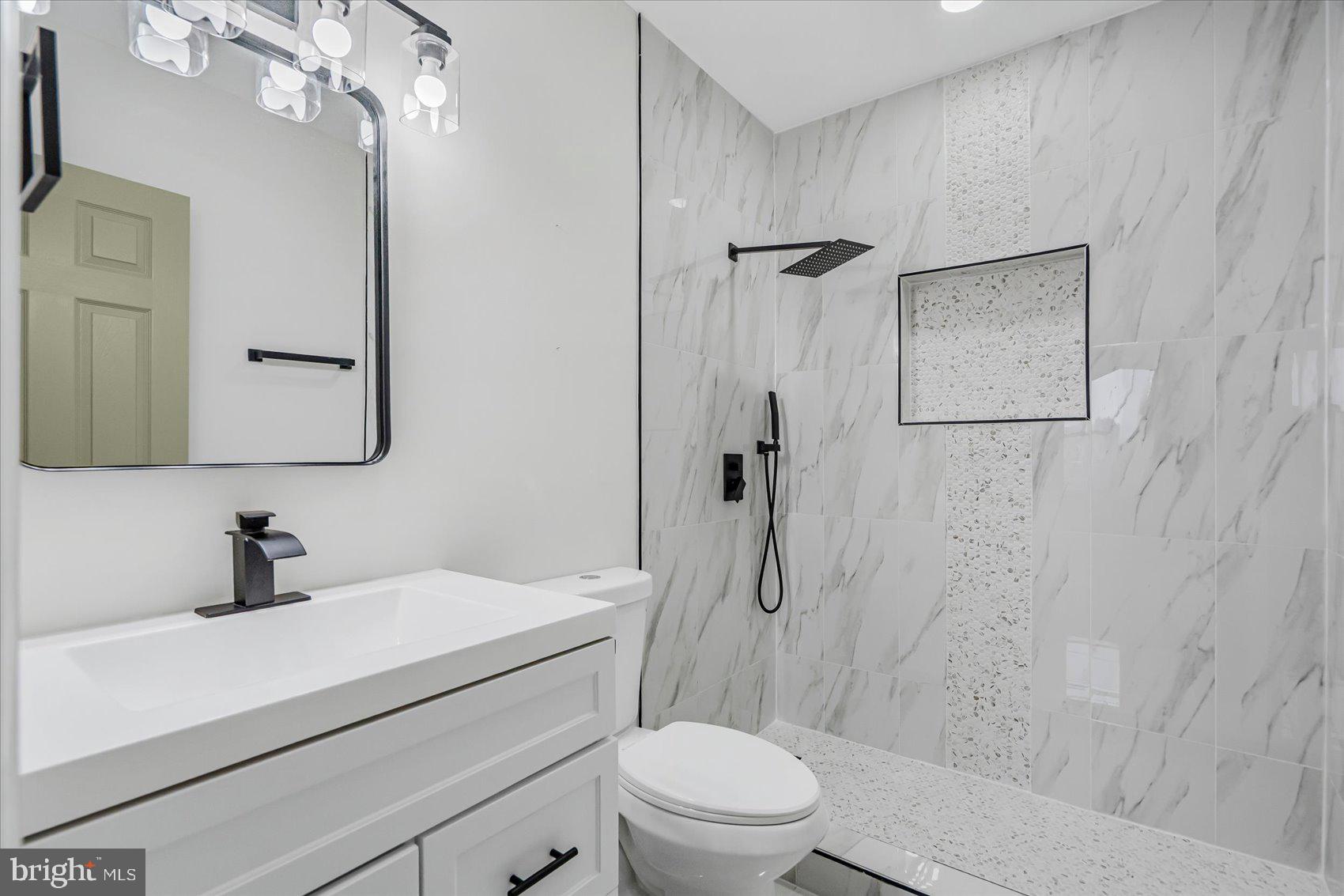 1743 Federal Street Baltimore, MD 21213 - Photo 4 of 47 a bathroom with a sink a toilet and shower