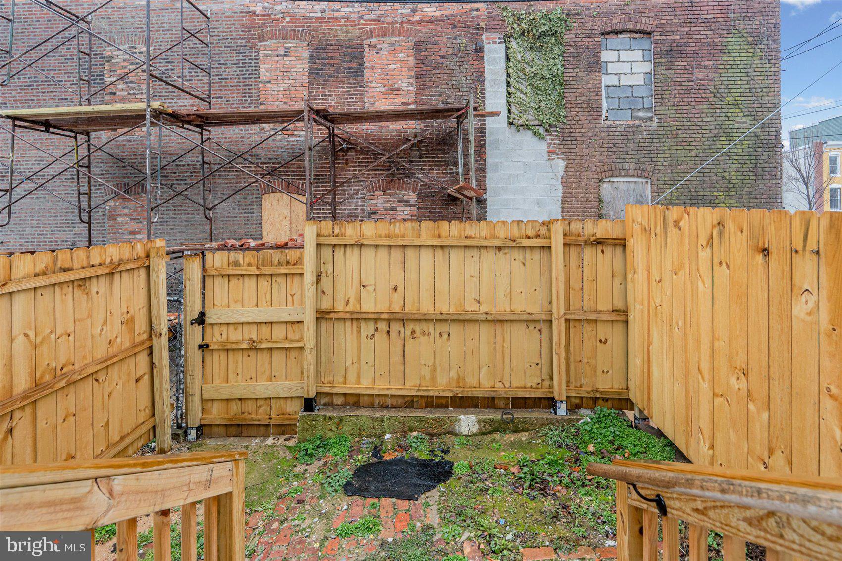 1743 Federal Street Baltimore, MD 21213 - Photo 43 of 47 a view of a backyard with a wooden fence