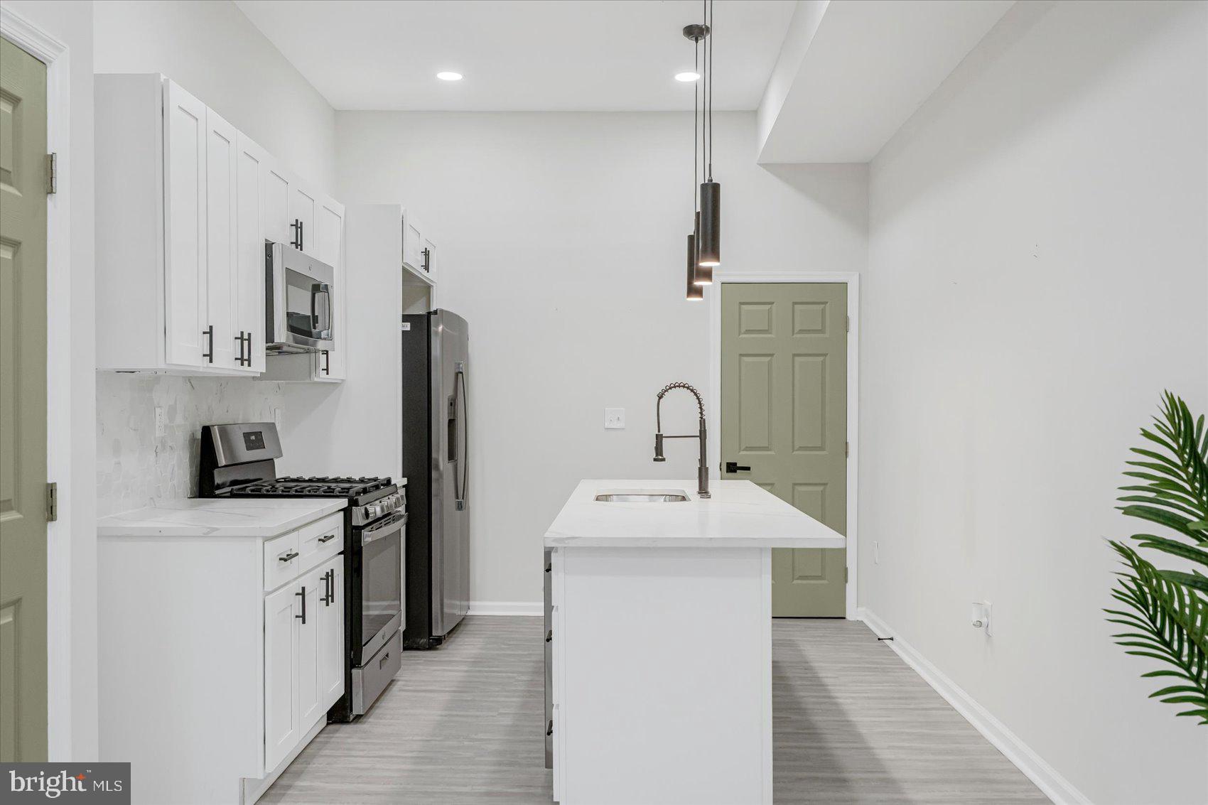 1743 Federal Street Baltimore, MD 21213 - Photo 10 of 47 a kitchen with stainless steel appliances granite countertop a sink stove and refrigerator