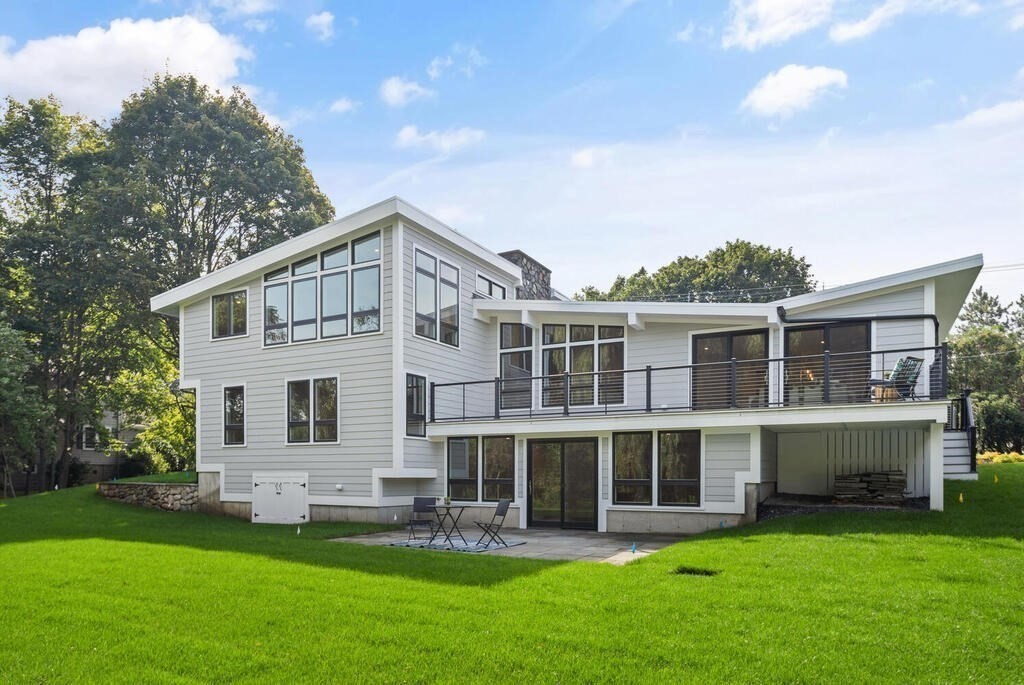a front view of a house with a yard and trees