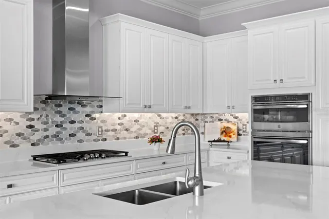 a bedroom with a bed a large window and furniture