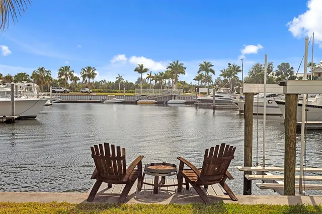 a living room with furniture a flat screen tv and a floor to ceiling window