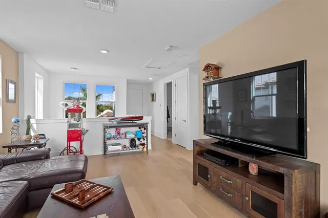 a front view of a house with a yard and potted plants