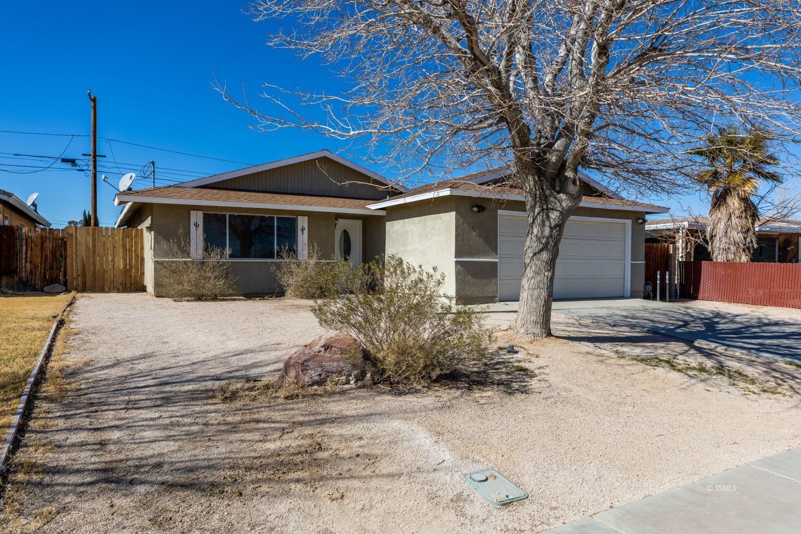 1425 Mayo Street Ridgecrest, CA 93555 - Photo 2 of 28 a front view of a house with a yard and garage