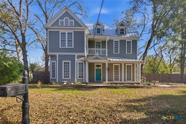 a view of a hallway view with wooden floor and staircase
