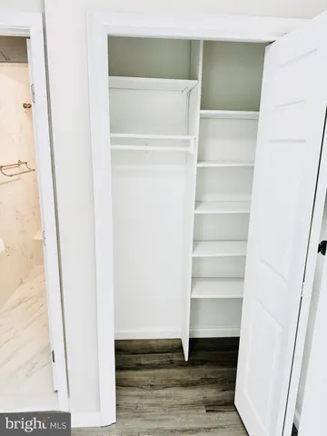 a view of walk in closet with empty racks