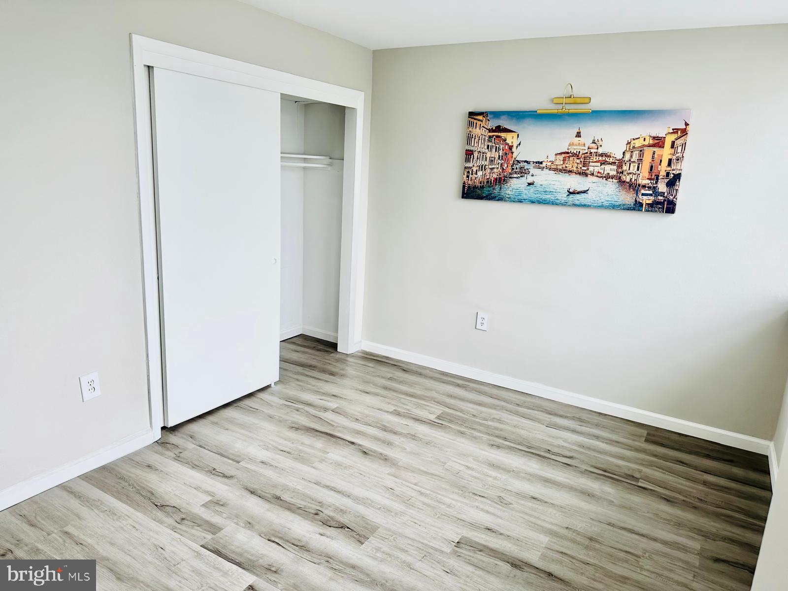 4401 Cherry Hill Road, Unit 67 Arlington, VA 22207 - Photo 19 of 23 an empty room with wooden floor and window