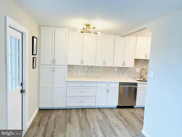 a view of kitchen with granite countertop cabinets and wooden floor