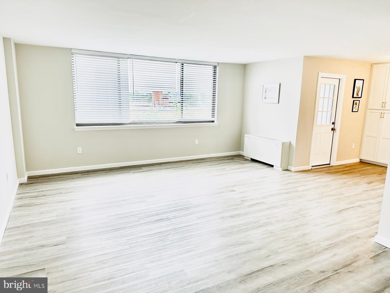 4401 Cherry Hill Road, Unit 67 Arlington, VA 22207 - Photo 20 of 23 an empty room with wooden floor and windows