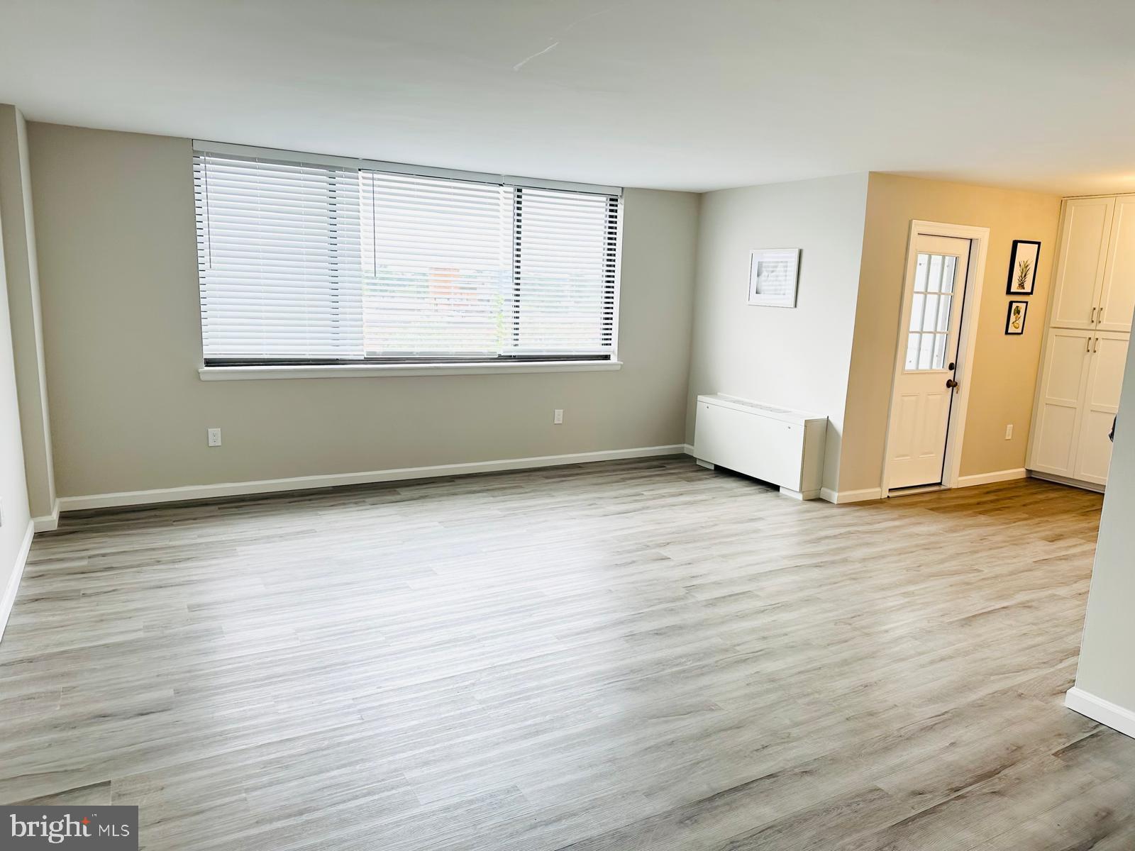 4401 Cherry Hill Road, Unit 67 Arlington, VA 22207 - Photo 7 of 23 an empty room with wooden floor and windows
