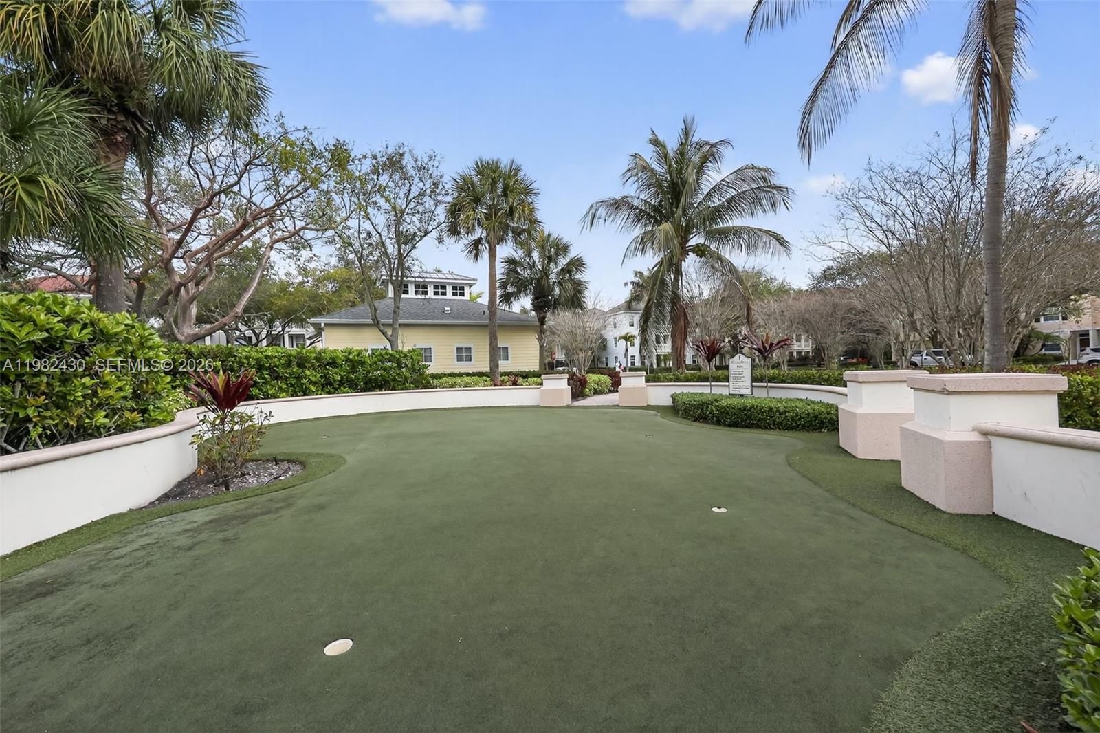 156 Aragon Way, Unit 103 Jupiter, FL 33458 - Photo 29 of 30 a view of a swimming pool and trees in the background