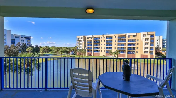 a view of a chair and table on the deck