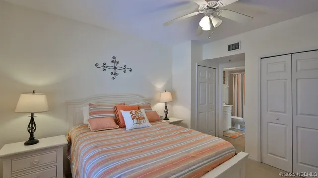 a bedroom with a bed and a lamp