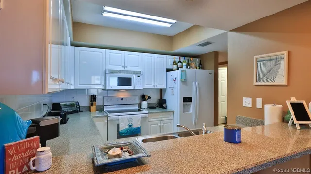 a kitchen with a refrigerator and sink