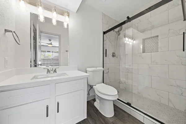 a bathroom with a sink toilet and shower