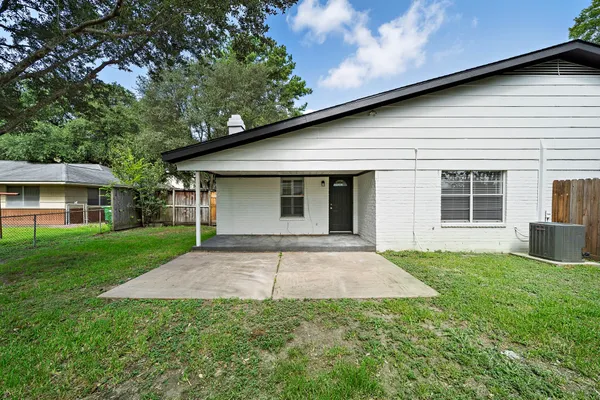 a front view of a house with a garden and yard