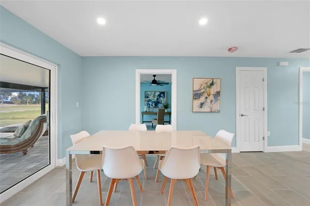 a view of a dining room with furniture and a window