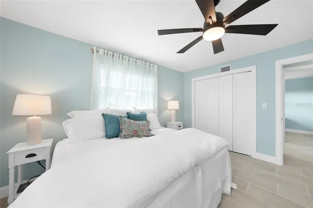 a bedroom with a large bed and a lamp