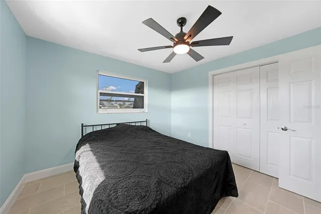 a bedroom with a bed and a painting on the wall