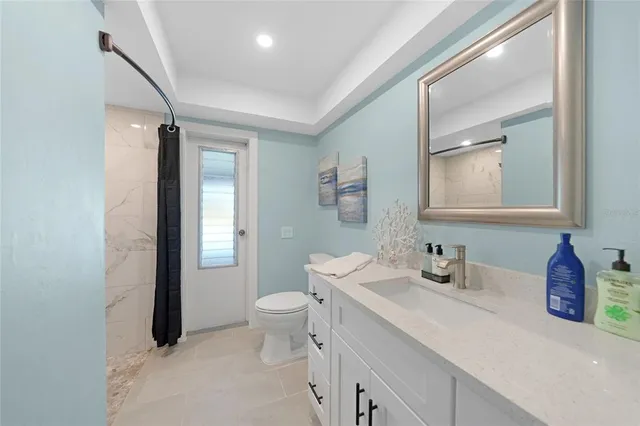 a bathroom with a double vanity sink toilet and mirror
