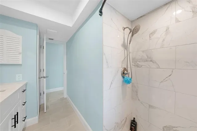 a bathroom with a shower and a sink