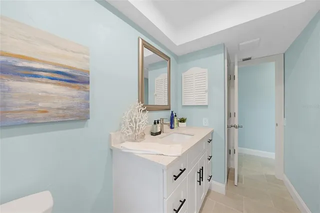 a bathroom with a sink vanity and a mirror